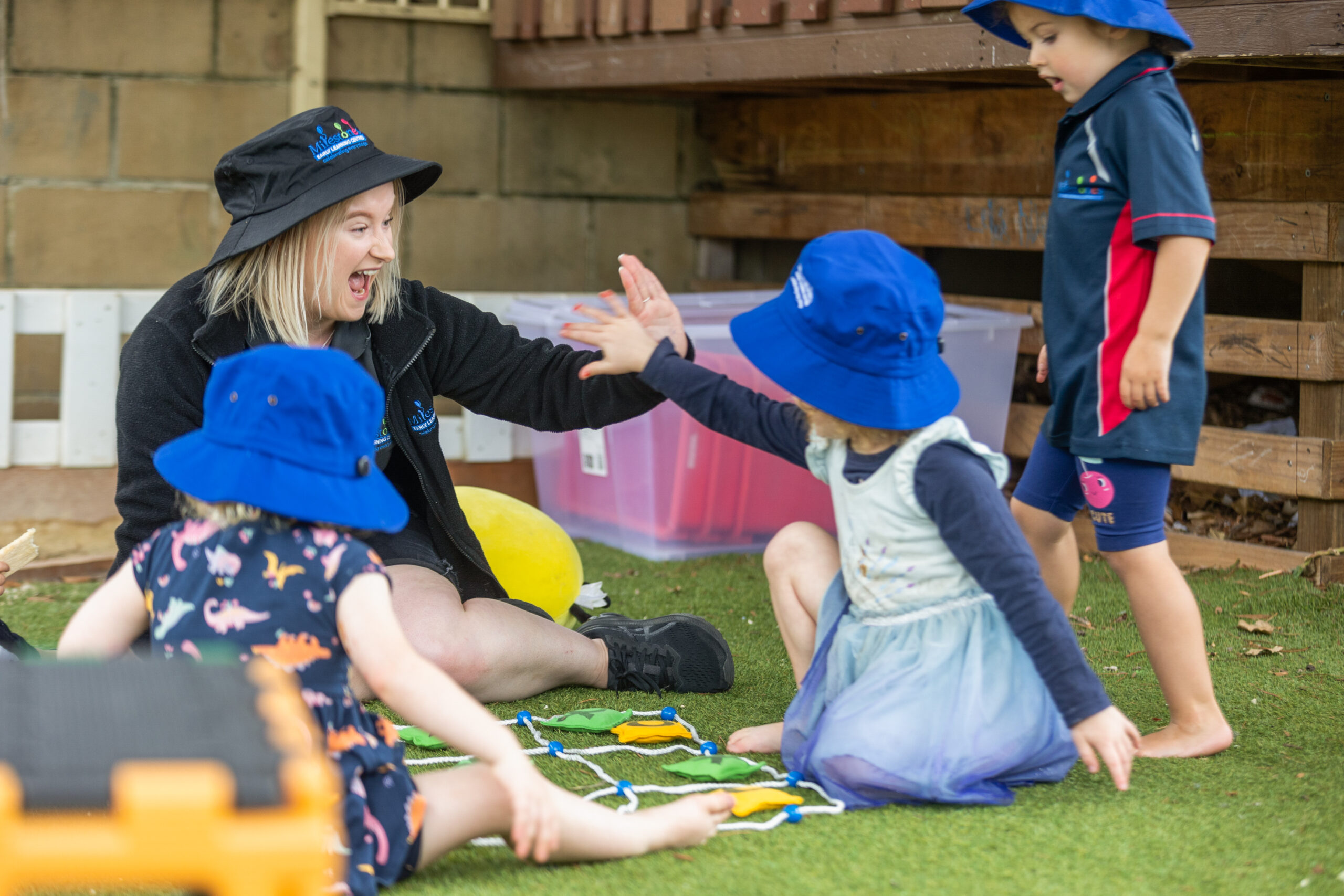 Milestones Blaxland | Early Education & Child Care in Blaxland | Educator and children enjoy play time at Milestones Blaxland