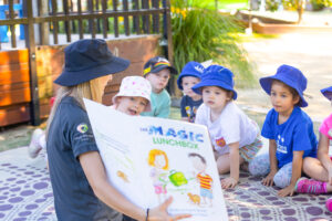 Milestones Mount Riverview | Early Education & Child Care in Mount Riverview | Educator and children reading a book